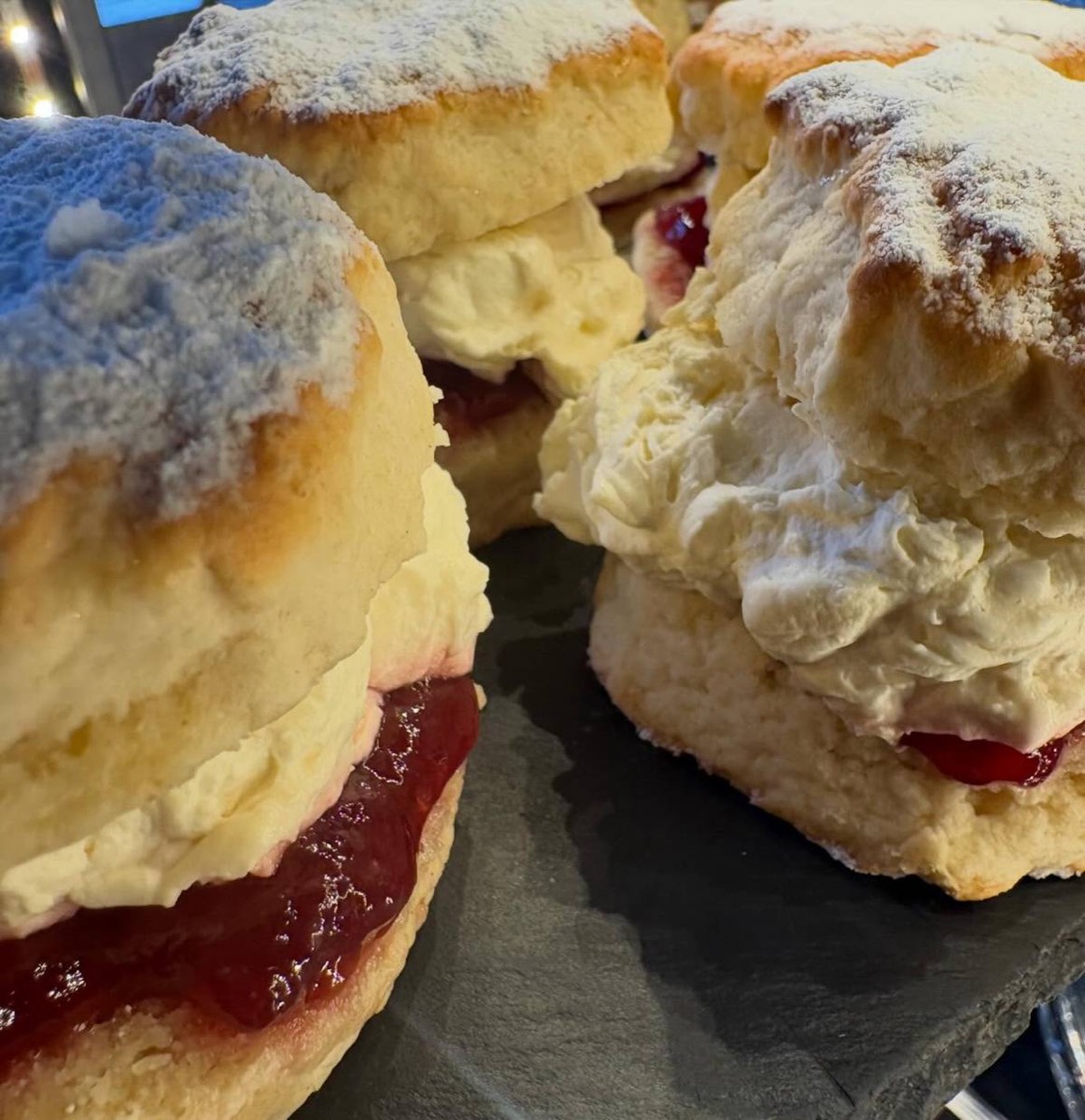 Scones piled high with jam and cream